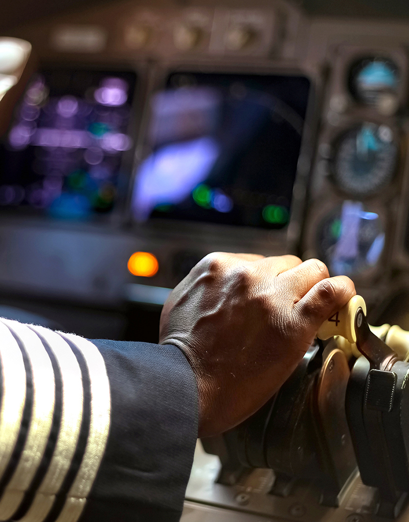 pilot with hand on thrust