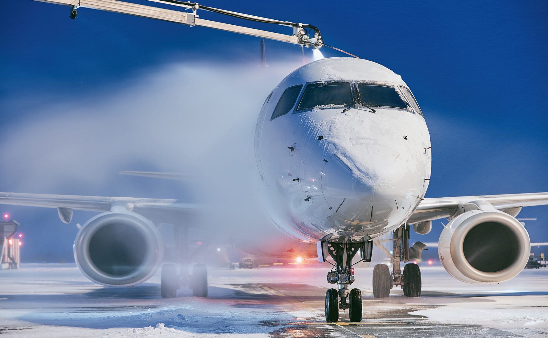 de-icing a plane on the tarmac
