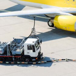 Airplane refueling with truck on tramac.