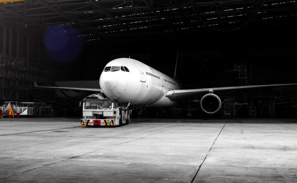 airplane being towed from hangar